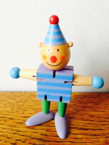 Little wooden jester doll