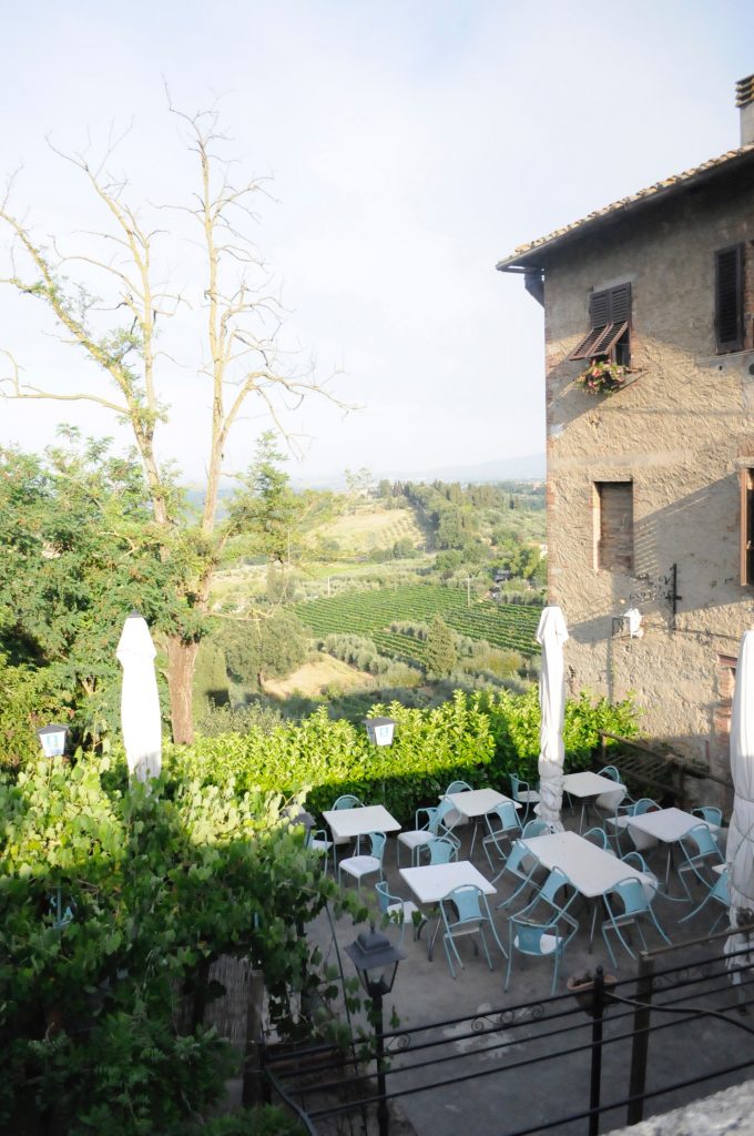 view of an outdoor restaurant on the side of a Tuscan hill