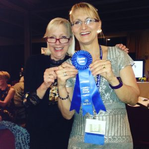 M A Clarke Scott with Chatelaine Prize category win blue ribbon, with Margie Lawson, writing coach