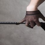 woman's hand, glove, whip, leg in stocking